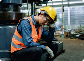 A man in an orange vest and hard hat.