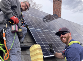 Two men working on a solar panel.